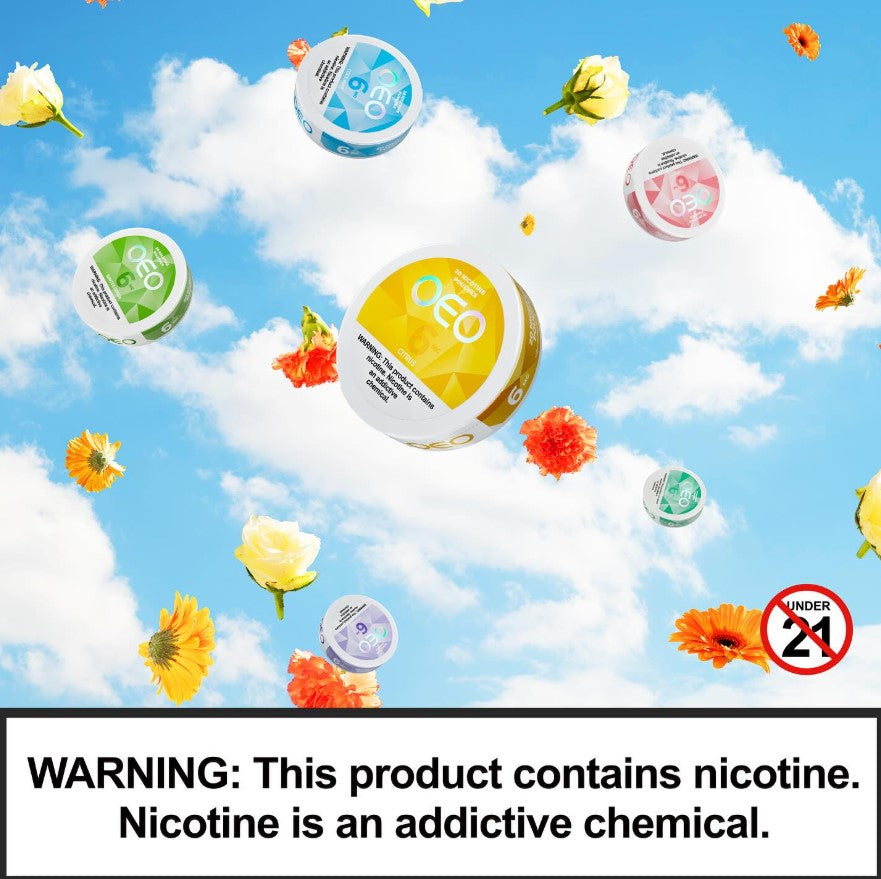 Multiple round nicotine products floating against a blue sky with white clouds and scattered flowers. A large yellow-labeled container is centered, with smaller green, blue, pink, and purple containers around it.