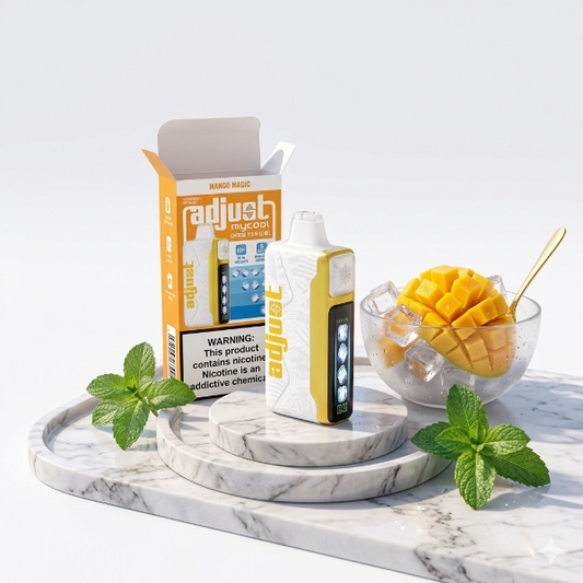Adjust vape device and packaging on a marble tray with mango and mint leaves.